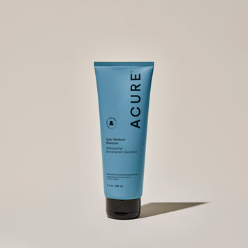A tube of ACURE Daily Workout Shampoo against a neutral background.